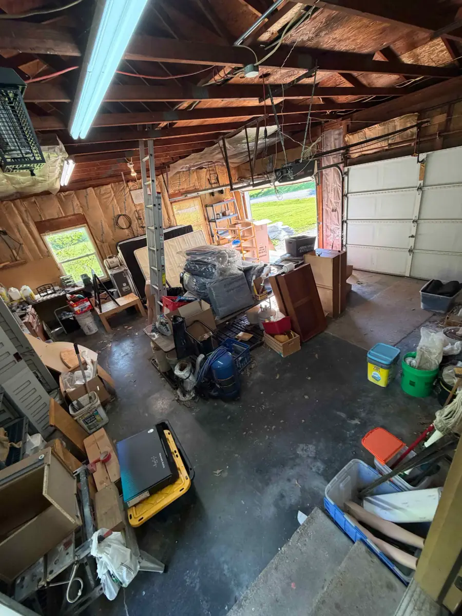 Garage packed with years of accumulated junk before property cleanout